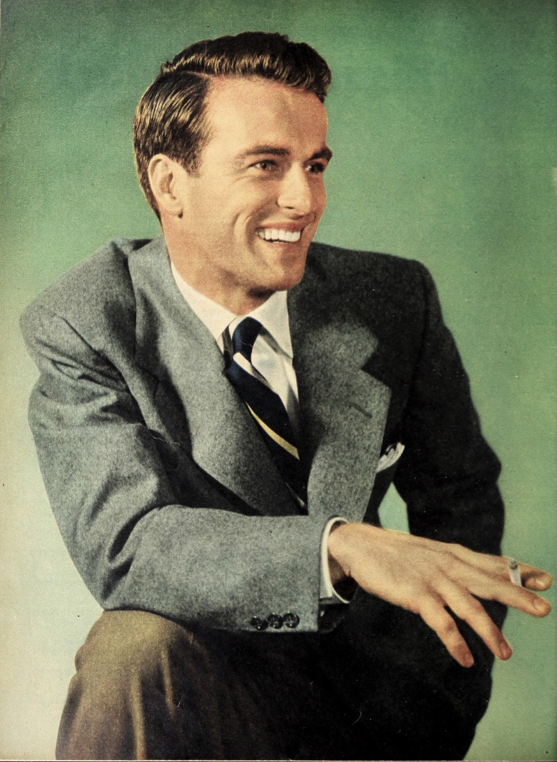 Montgomery Clift wears a classic side part hairstyle for a 1950s studio portrait.