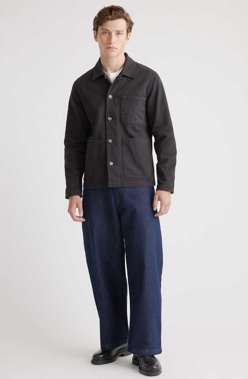 A chore jacket and loose denim embody quiet strength with workwear credibility.