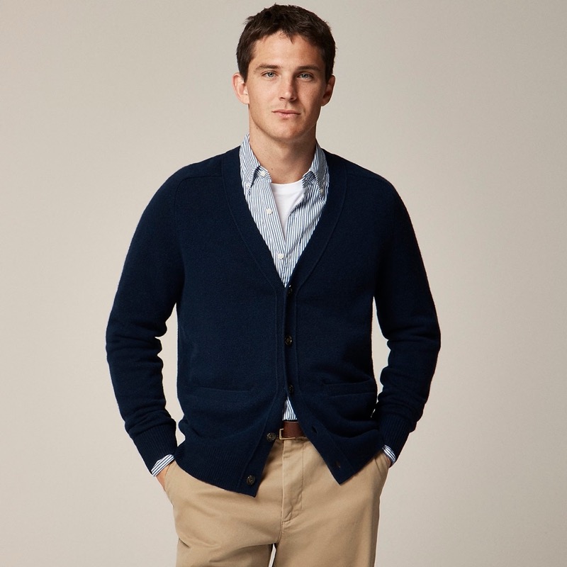 Business casual style takes the spotlight with a navy blue cardigan outfit that features a striped Oxford shirt. 