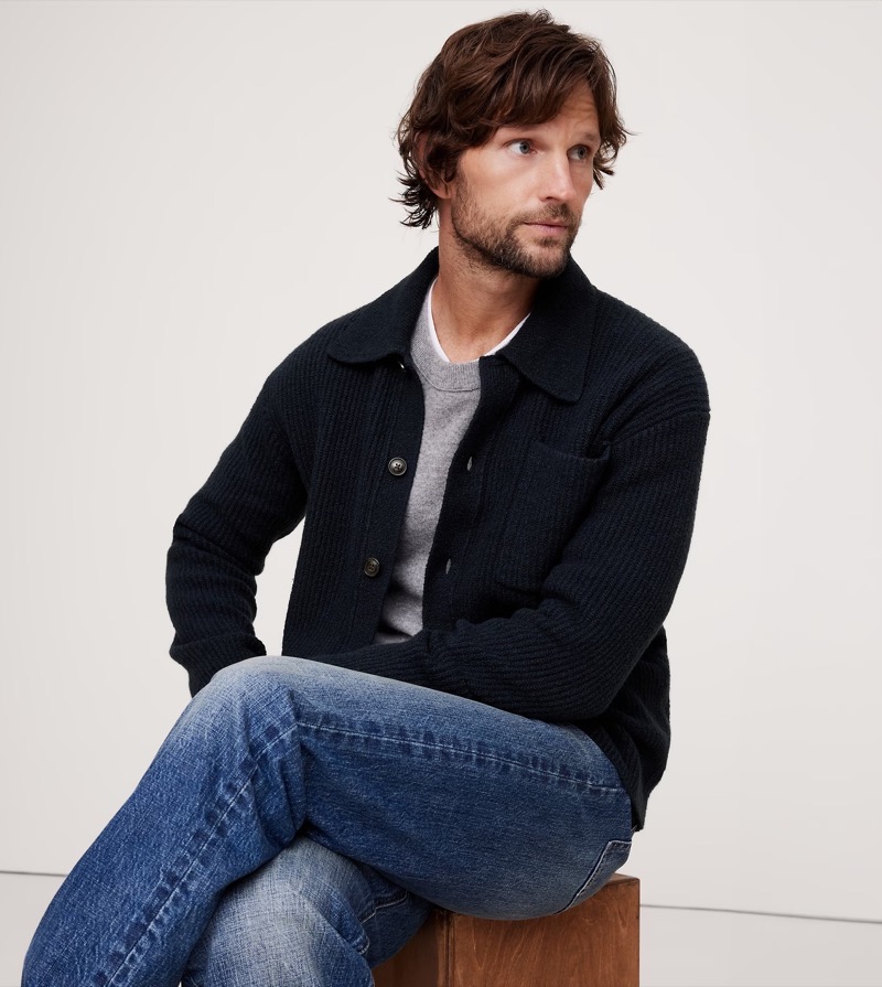 A ribbed polo-style cardigan worn over a crew neck sweater and jeans creates a casual, layered look.