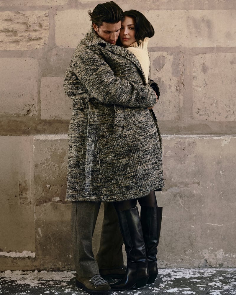 Max Knott embraces Ella Hunt in a textured overcoat in Paris.