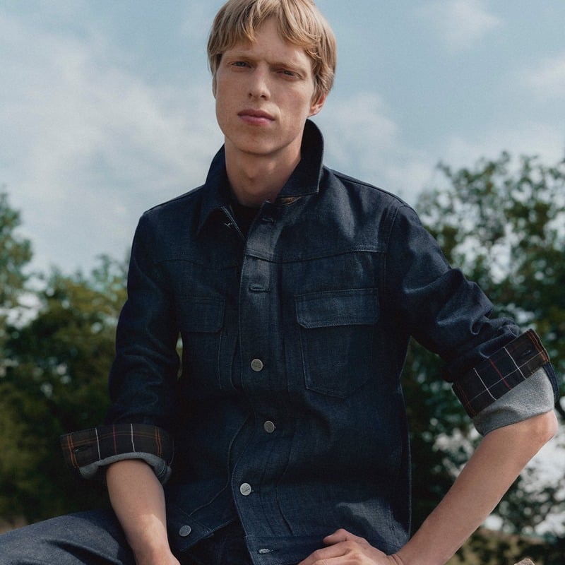 Joseph Uyttenhove wearing a denim jacket with turned-back tartan cuffs for Barbour x A.P.C.
