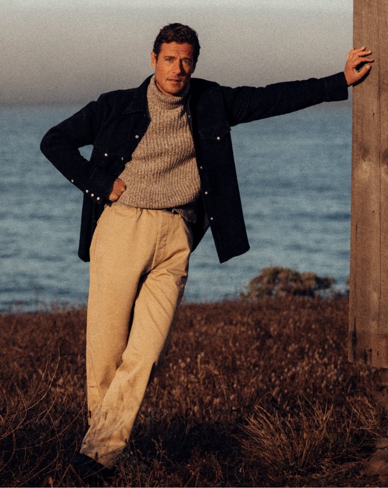 Jon Paul Phillips wears a navy deck jacket with a sweater and chinos.