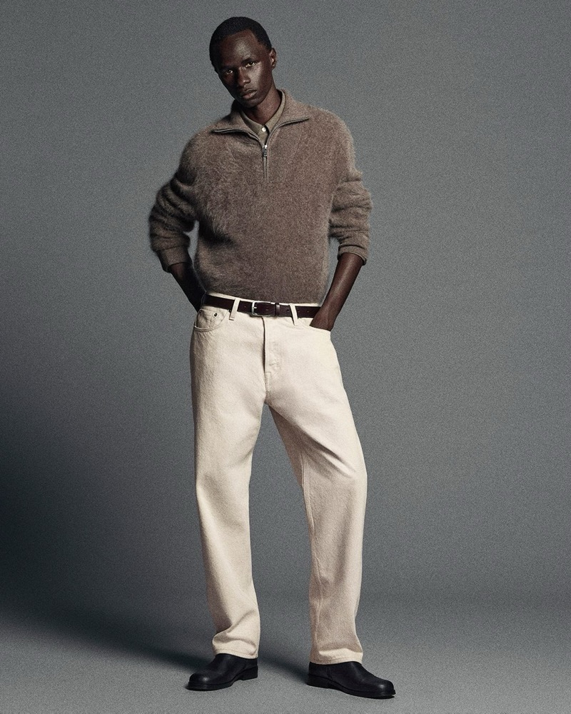 malick bodian wears a cashmere zip sweater with ecru jeans