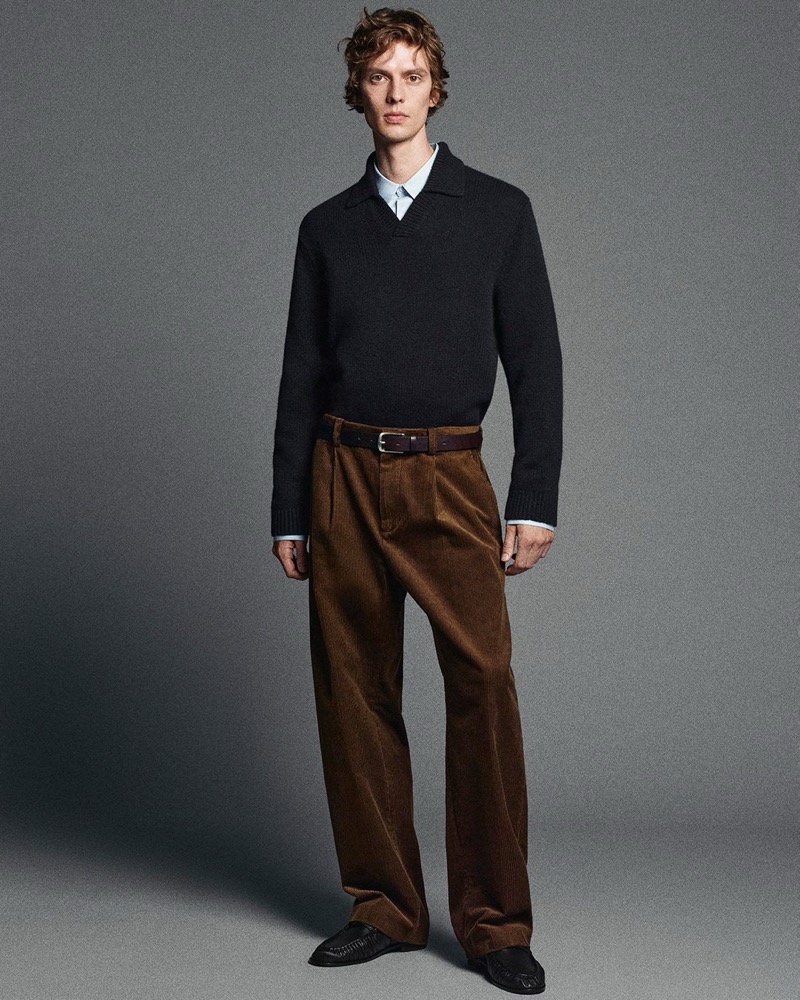 leon dame wears a cashmere polo sweater with corduroy trousers