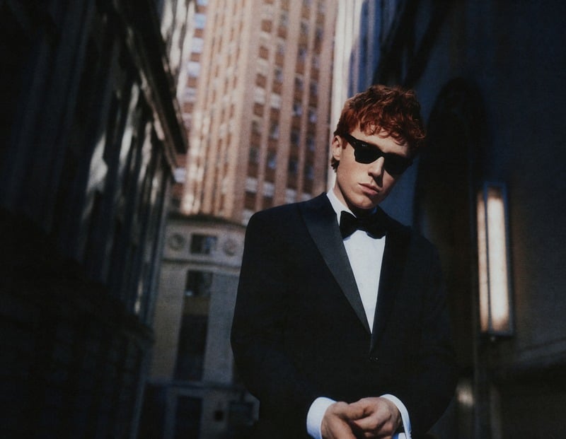 Ben Marshall wears a dark tuxedo and bow tie on a New York street.