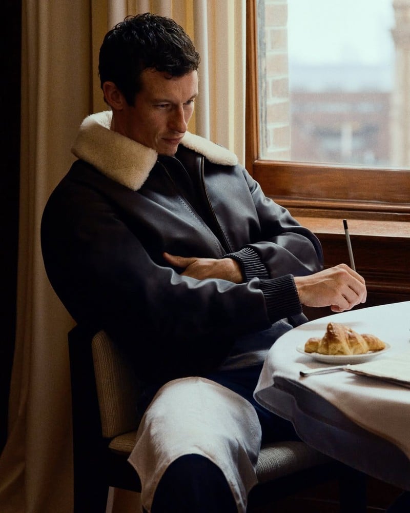 Callum Turner wears a leather blouson at breakfast in the Louis Vuitton Trunk Edition campaign.