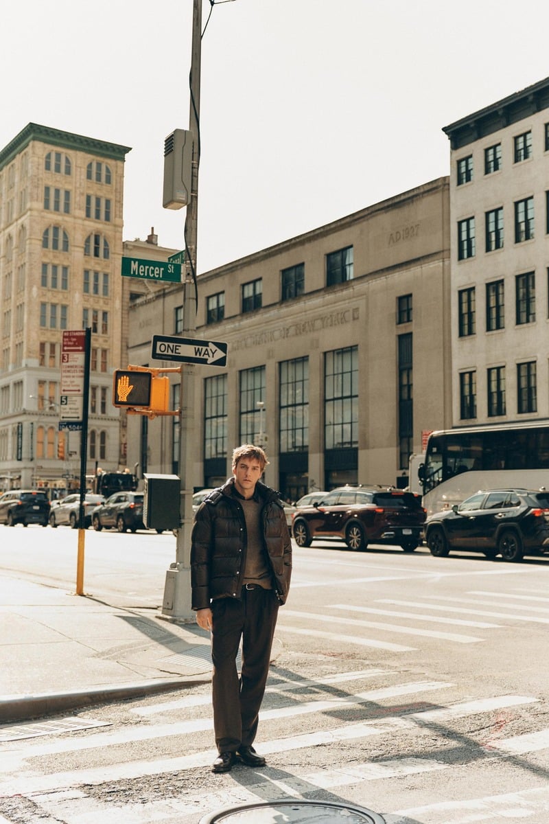 Quentin Demeester stands on a New York street corner in a padded jacket and dark trousers for Massimo Dutti's fall 2026 New York edit.