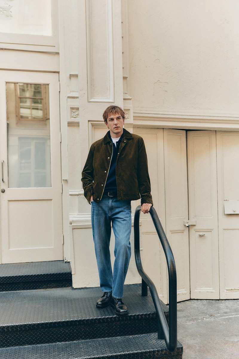 Quentin Demeester stands on a stoop in a short jacket with a navy polo and jeans for Massimo Dutti's fall 2026 New York edit.