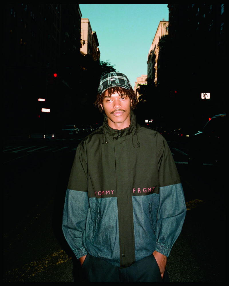 Nile Winchester wears a color-block Tommy Hilfiger x FRGMT jacket with a plaid cap.