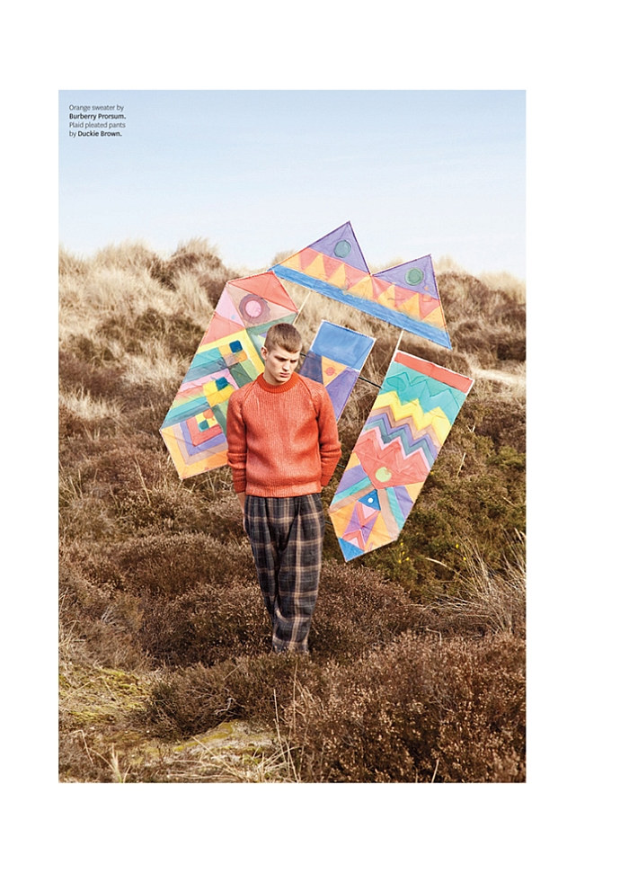 Sebastian Sauve enjoys a tranquil moment in a bright orange knit from Burberry Prorsum, appearing in Out magazine photographed by Thomas Giddings.