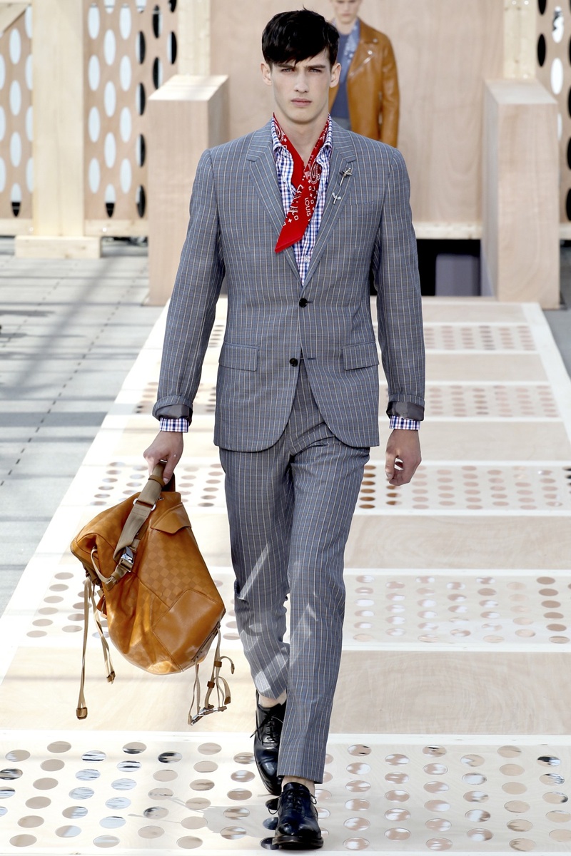 A model displays a creation by designer Kim Jones for Louis Vuitton  Fall-Winter 2015/2016 men's collection presentation held at the grande  Serre, Parc Andre Citroen in Paris, France, on January 22, 2015.