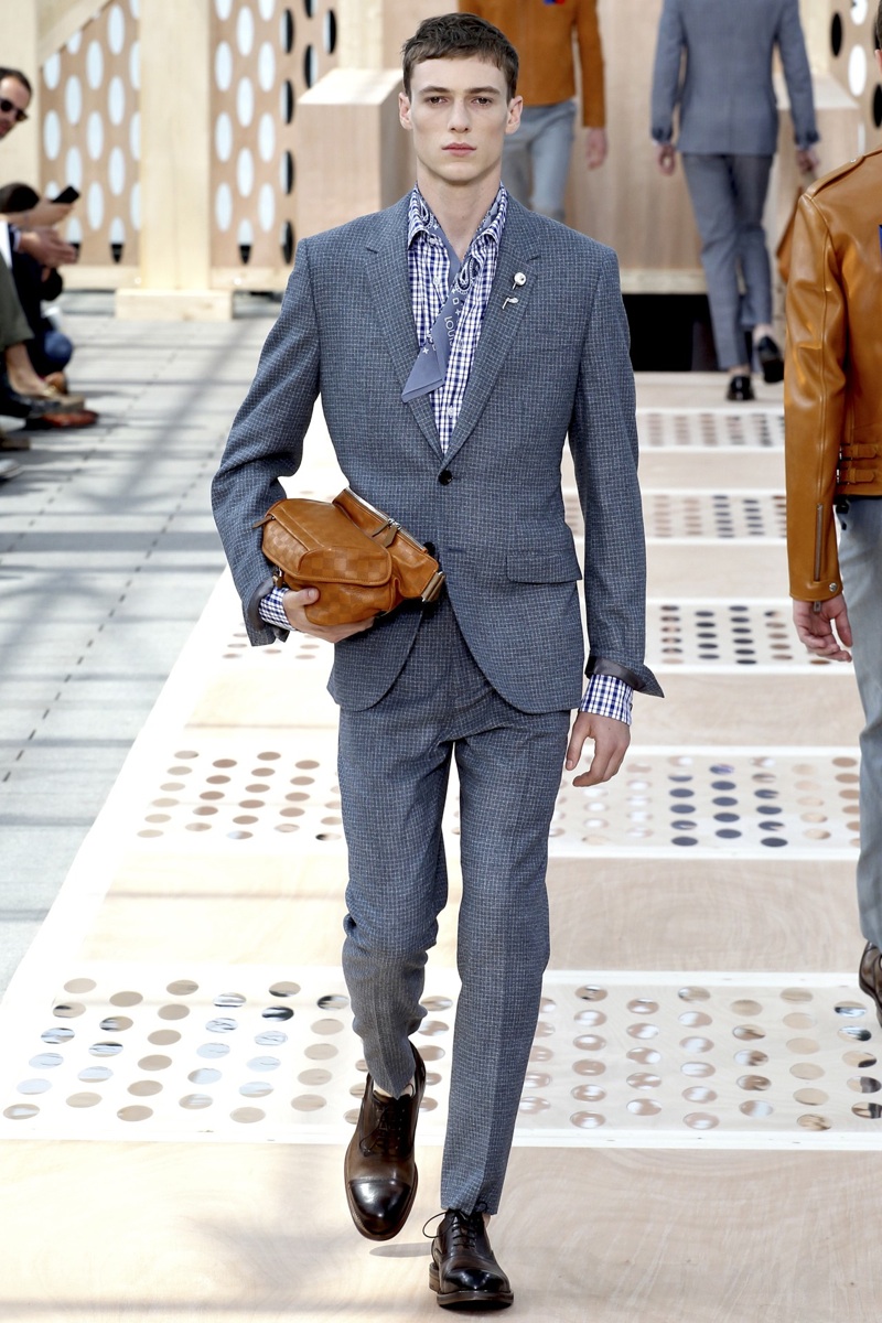 A model displays a creation by designer Kim Jones for Louis Vuitton  Fall-Winter 2015/2016 men's collection presentation held at the grande  Serre, Parc Andre Citroen in Paris, France, on January 22, 2015.