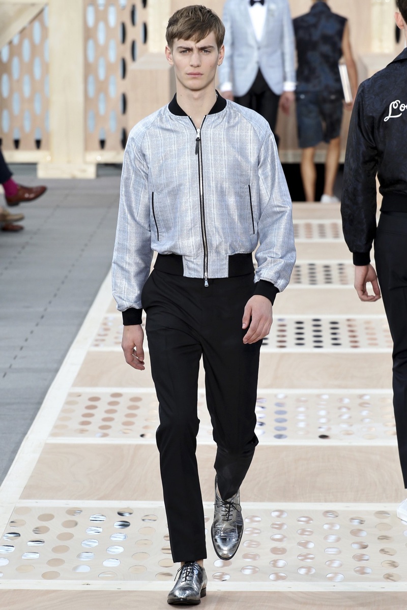 A model displays a creation by designer Kim Jones for Louis Vuitton  Fall-Winter 2015/2016 men's collection presentation held at the grande  Serre, Parc Andre Citroen in Paris, France, on January 22, 2015.