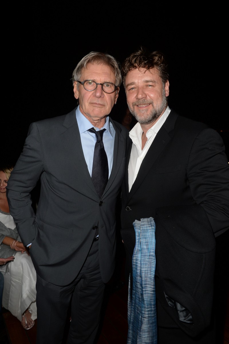 Actors Harrison Ford and Russell Crowe pose for a photo together, both dressed in Giorgio Armani