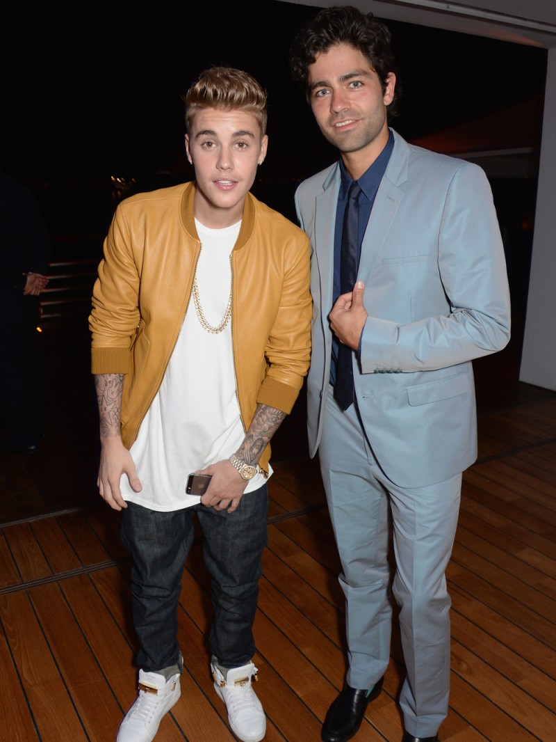 Singer Justin Bieber and actor Adrian Grenier pose. While Grenier sported a suit for the event, Bieber looked like a party crasher in a leather bomber.