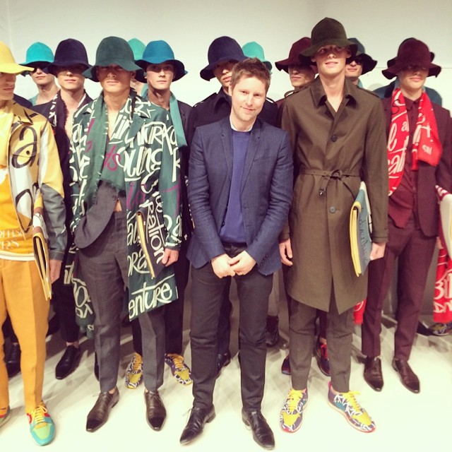 Designer Christopher Bailey poses with models backstage at his latest show for Burberry Prorsum.