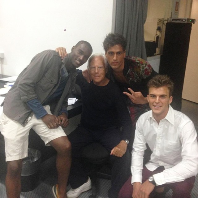 Corey Baptiste, Fabio Mancini and Patrick Kafka pose backstage with designer Giorgio Armani.