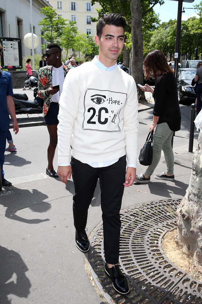 Joe Jonas checks out the first day of Paris Fashion Week. Heading to Carven's spring/summer 2015 show, Jonas wears a look from the brand featuring its 'Eye Hope 2 C U' sweatshirt.