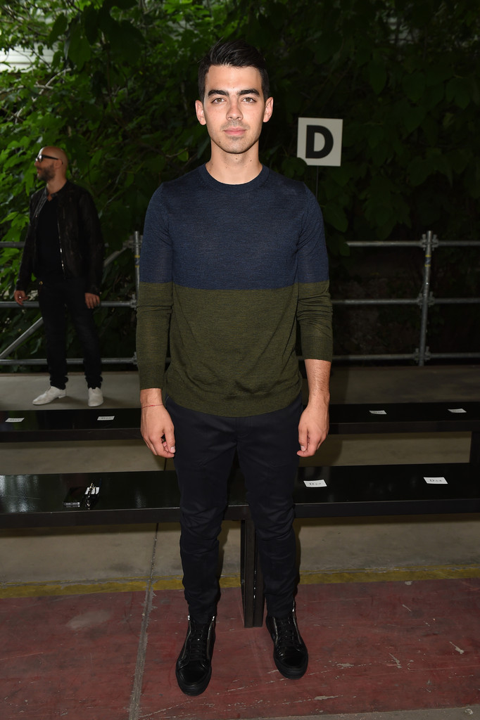 Playing it cool and casual, Joe Jonas hit up Diesel Black Gold's spring/summer 2015 show in a color blocked sweater with plain trousers.