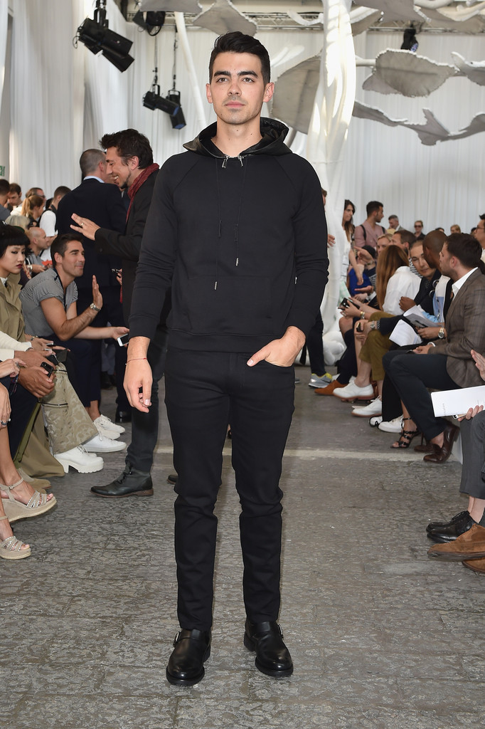 Understated in a black hooded pullover and pants, Joe Jonas was a front row guest at John Varvatos' latest show during Milan Fashion Week.