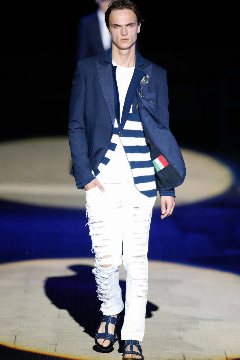 Philipp Plein Spring/Summer 2015: Designer Philipp Plein plays the role of the rebel for spring, mixing and matching styles for a cheeky take on nautical and preppy design motifs. Here, a structured, double-breasted jacket out of denim is paired with white, ripped denim jeans.