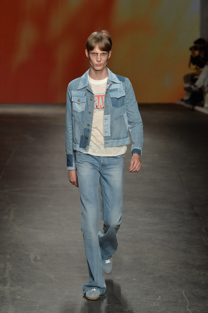 Topman Design Spring/Summer 2015: Topman Design revisits the iconic 1970s days of Woodstock for its contribute to the denim trend. Topman denim embraces distressing and flared legs for jeans, while denim jackets blend different rinses in the form of a cropped jacket.