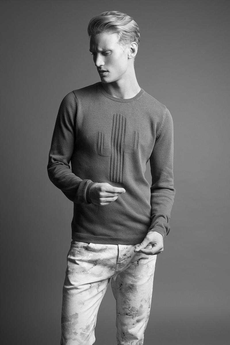 Alexander wears sweater Zara and  jeans McQ by Alexander McQueen.
