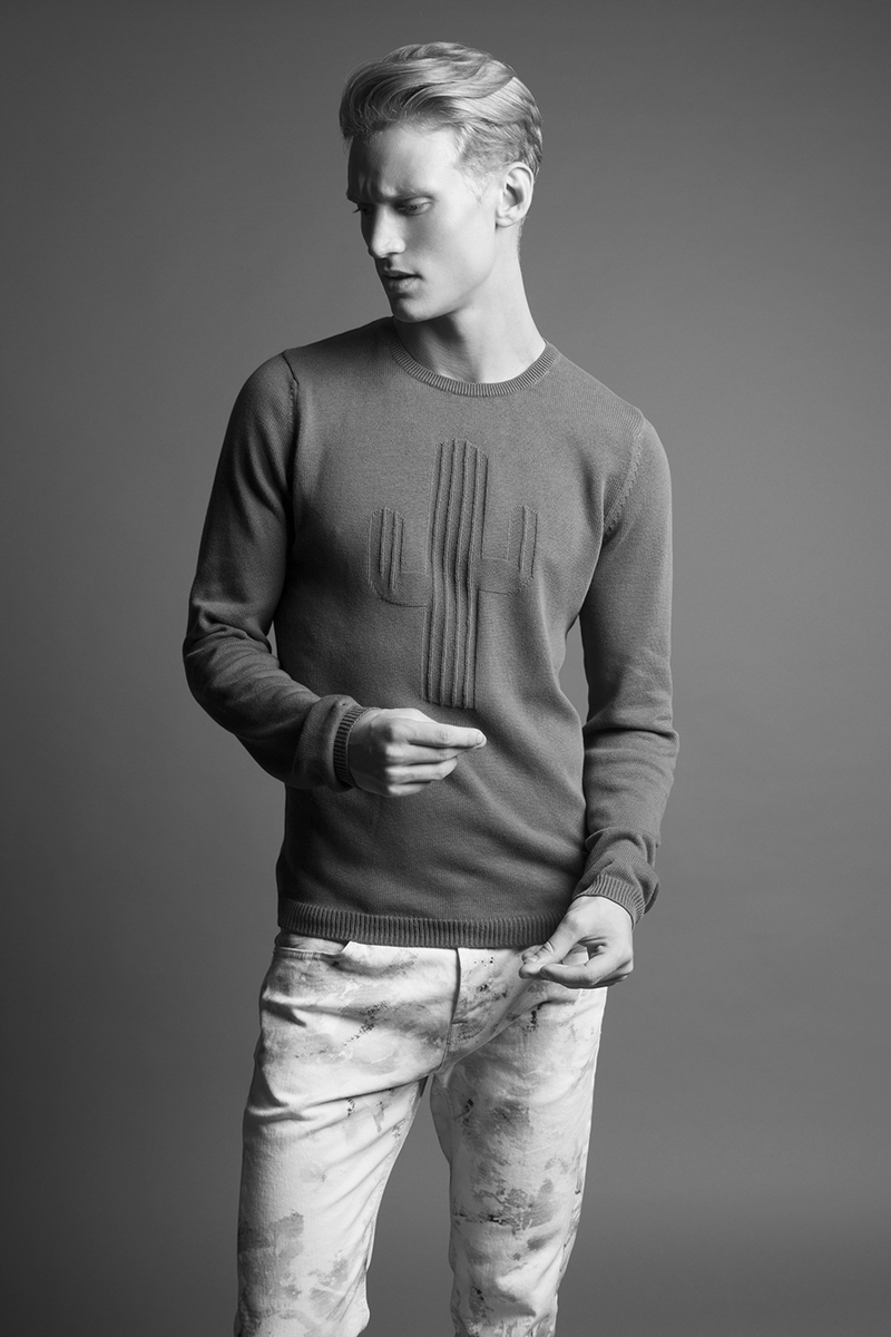 Alexander wears sweater Zara and  jeans McQ by Alexander McQueen.