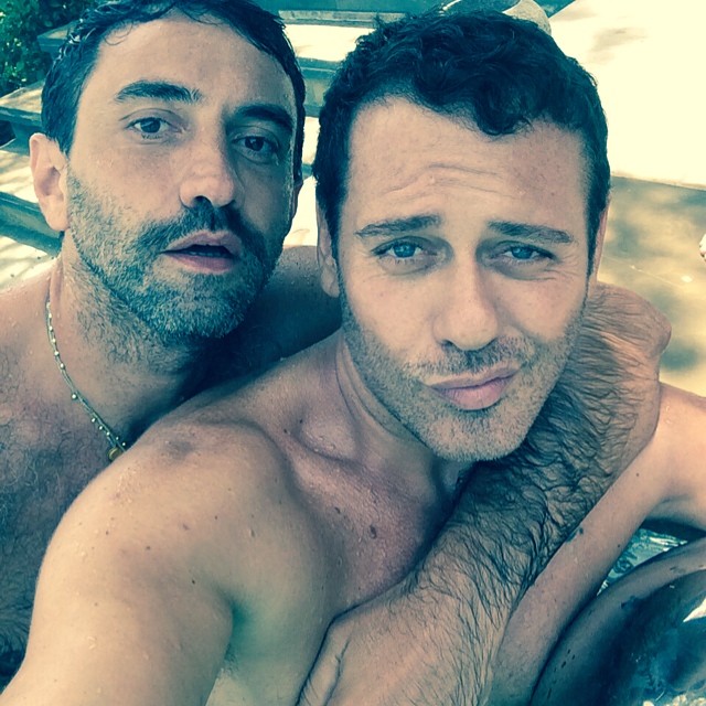 Riccardo Tisci and Mert Alas pose for a pool image.