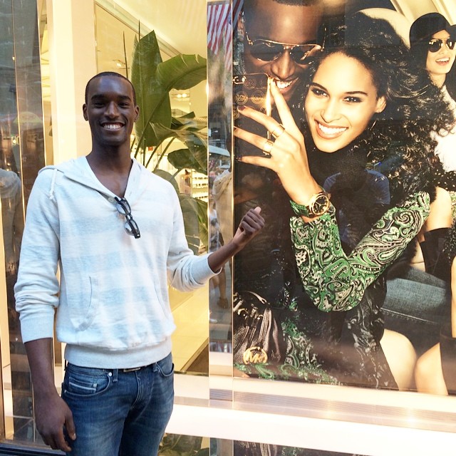 Corey Baptiste poses with his Michael Kors campaign.