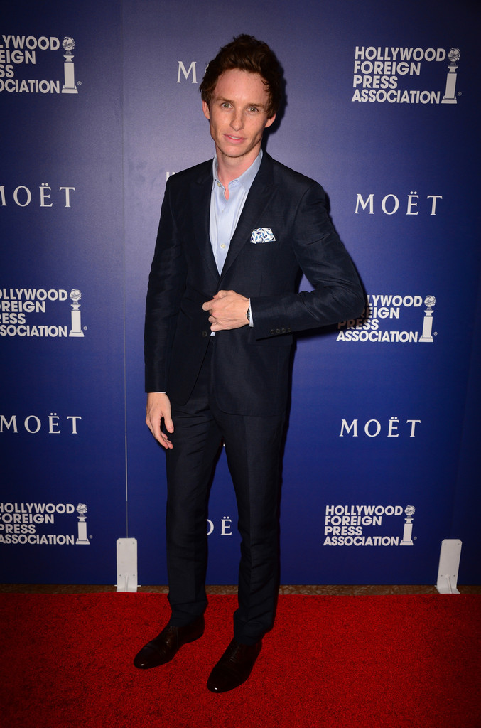 Eddie Redmayne exudes a young dapper spirit in a slim suit with pocket scarf.