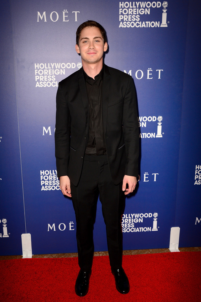 A vision in black with hair to match, actor Logan Lerman wears a Dior Homme wool two-button small lapel suit with denim lining, a black cotton shirt and black leather derbies.