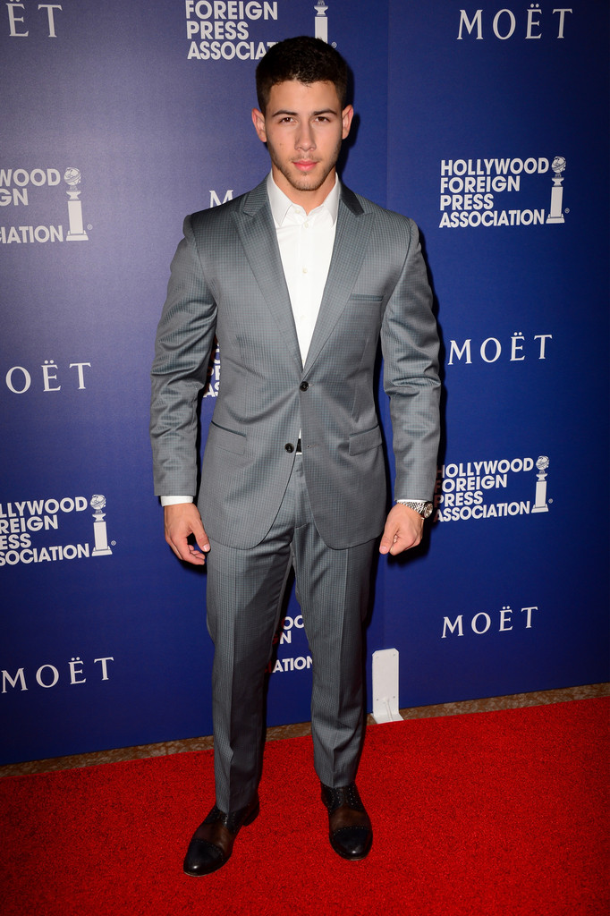 Nick Jonas cozies up to gray with a two-button suit with pleated trousers.