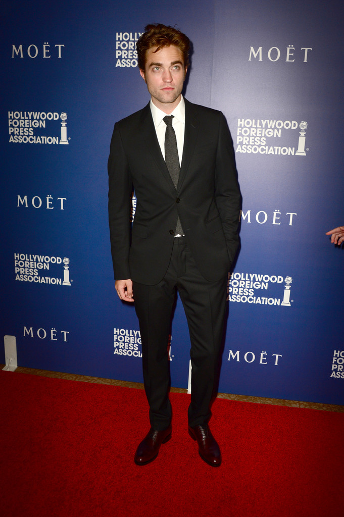 British actor Robert Pattinson keeps things simple in a black Gucci suit.