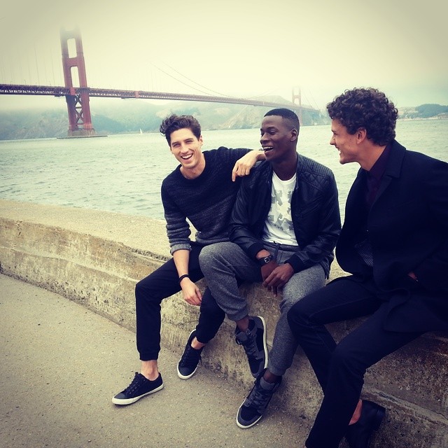 Ryan Kennedy, David Agbodji and Simon Nessman pose by the Golden Gate Bridge.