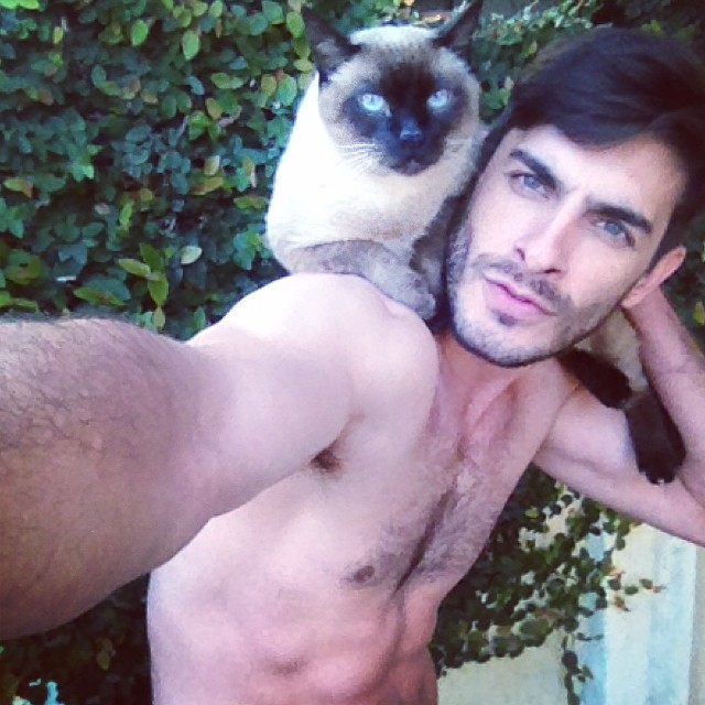 Tao Fernandez strikes a pose with a cat.