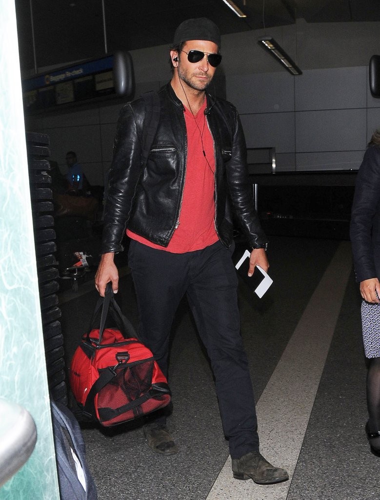 Bradley Cooper traveled in comfort as he touch down at LAX on September 23, 2014. Following events surrounding London Fashion Week, Cooper was spotted in a casual black and red ensemble, finished with a moto style leather jacket.