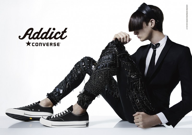 MMO model Corentin Renault delivers an intriguing edge for Converse Addict's fall/winter 2014 campaign. The model is featured with a long set of bangs, a tailored suit jacket, skinny tie and bejeweled pants, completed with a pair of Converse.