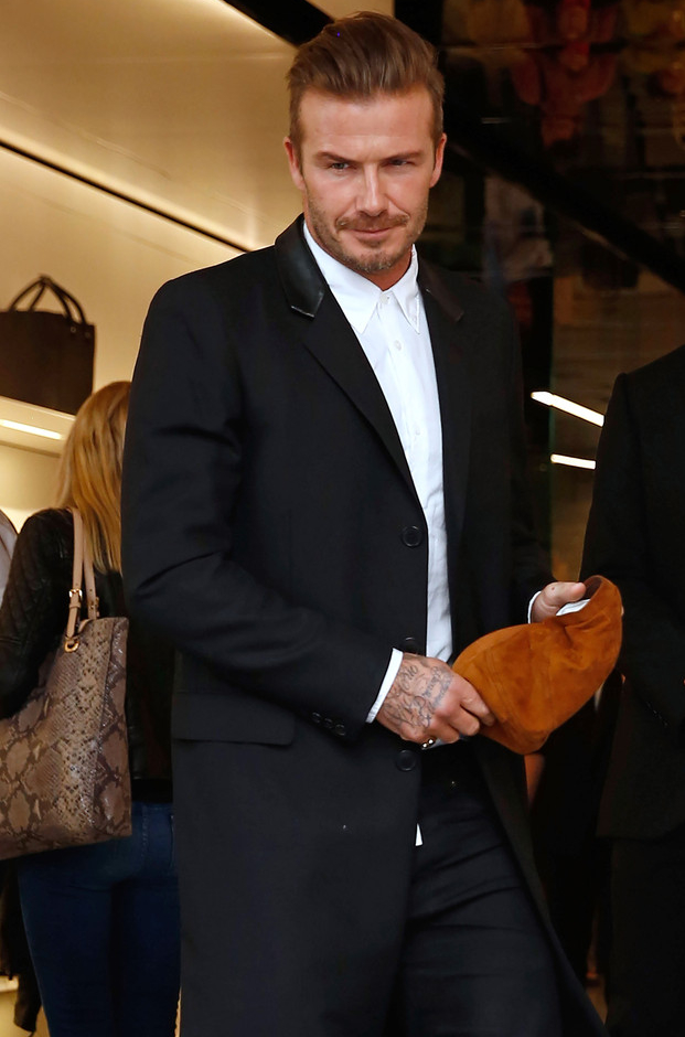 On September 25th, David Beckham attended the opening of his wife Victoria's new Dover Street flagship store in London. For the occasion, he was pictured in a coat with a leather collar from Saint Laurent.