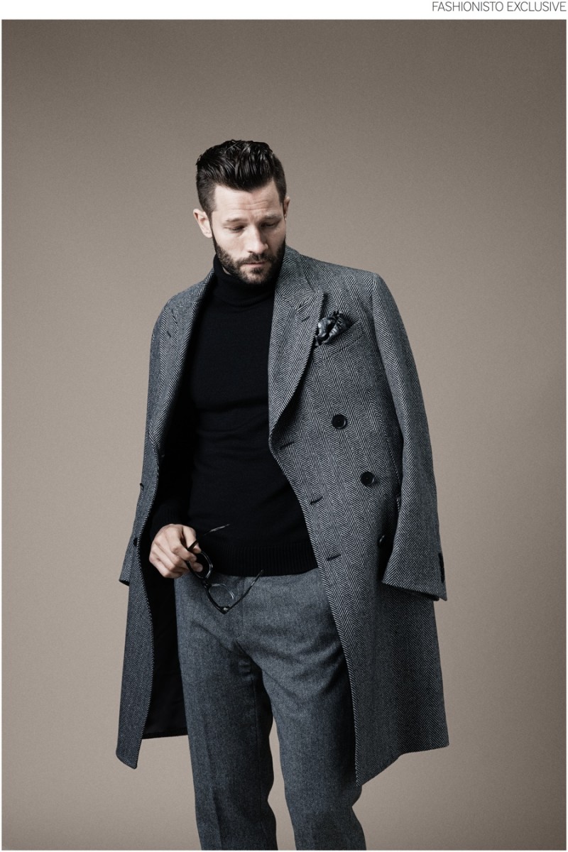 John wears polo neck sweater Hackett, trousers Nicole Farhi, eyewear Cutler & Gross, coat and pocket square Paul Smith.