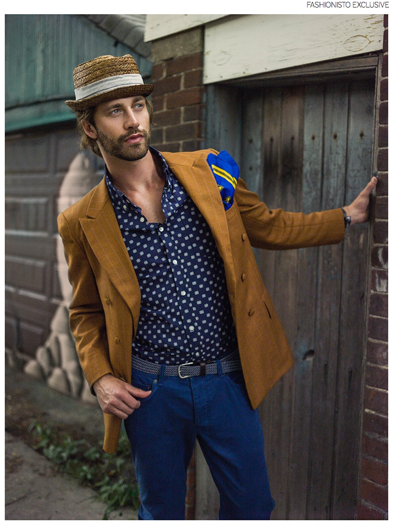 Josh wears pinstripe blazer stylist's own, shirt Joe Fresh, pants H&M, pocket scarf Oscar de la Renta and hat Zara.