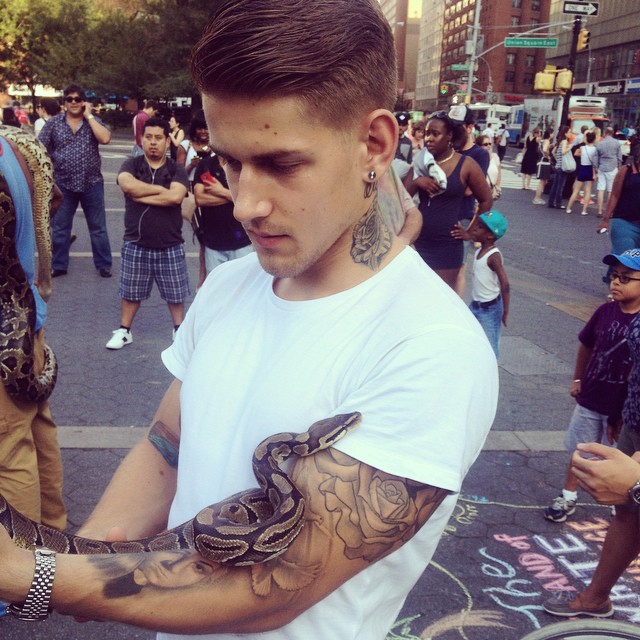 Igor Stepanov finds a snake friend in Washington Square.