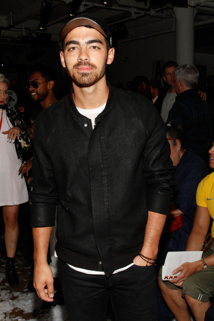 Joe Jonas attends Public School's spring 2015 show, wearing one of its on-trend bomber jackets.