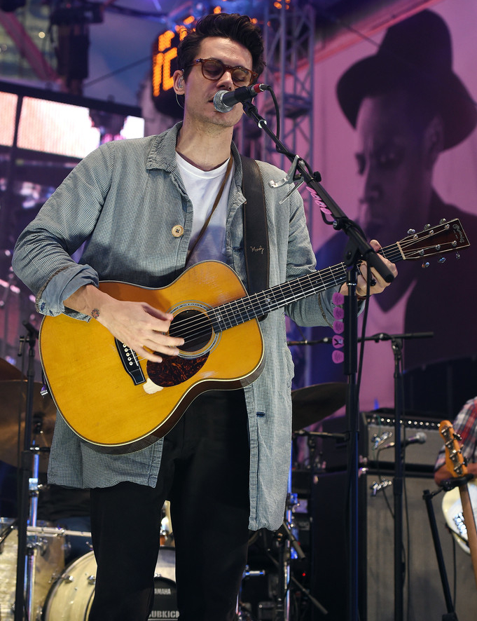 Performing at 'Rock the Rio USA' in Times Square on September 26, 2014, singer John Mayer continued his 50s-inspired style trek with a long mico-gingham print jacket, paired with a simple tee and high-waisted pants.