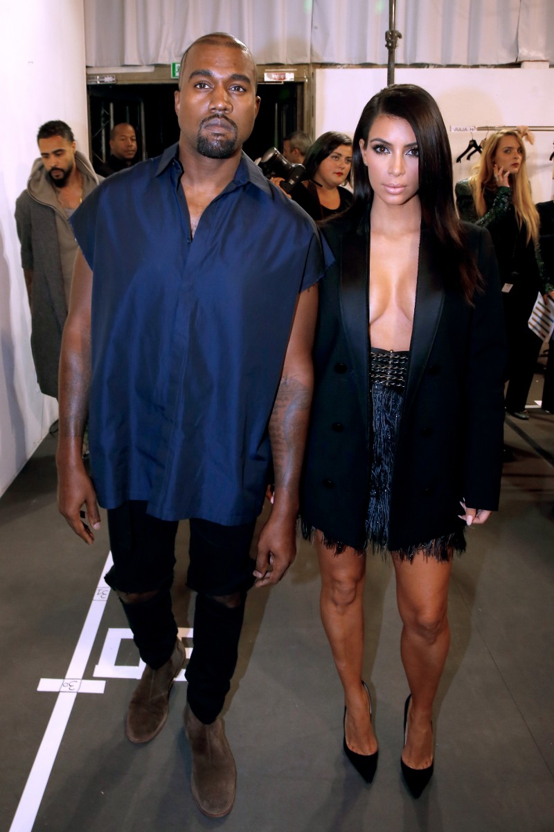 Kanye West and Kim Kardashian pose for a photo backstage