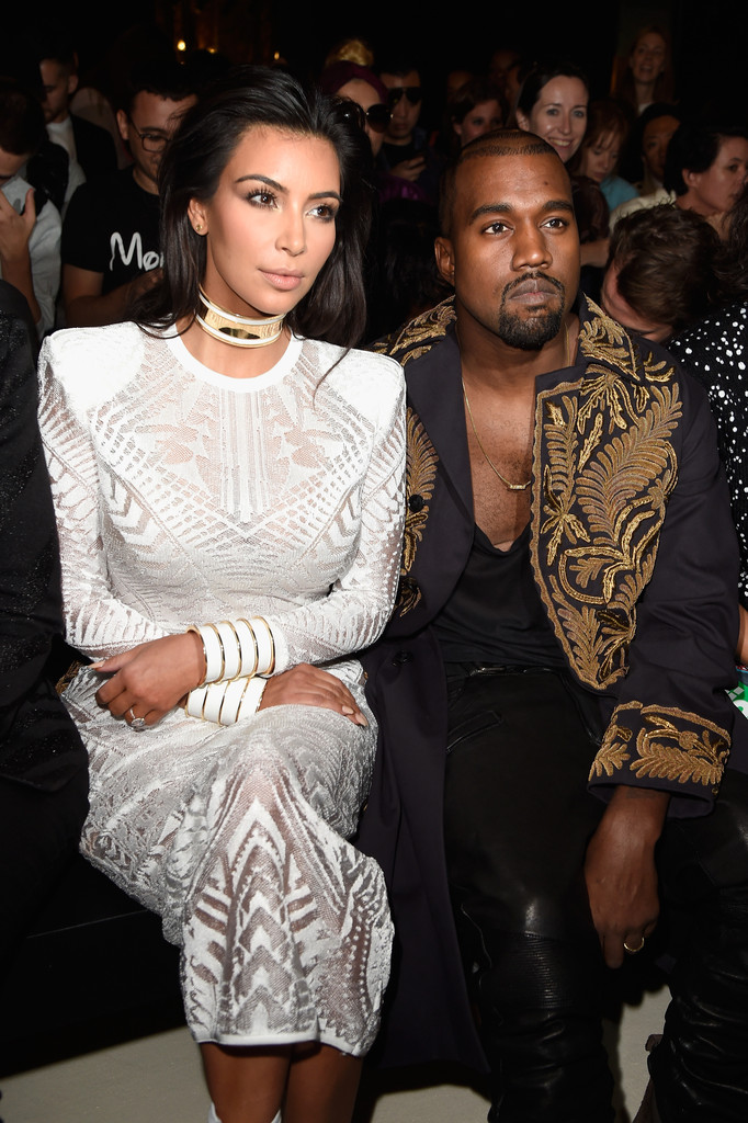 Attending Balmain's spring 2015 show during Paris Fashion Week, rapper Kanye West was accompanied by his wife Kim Kardashian. For the special occasion, West wore an embroidered coat from Dries Van Noten's spring/summer 2014 collection.