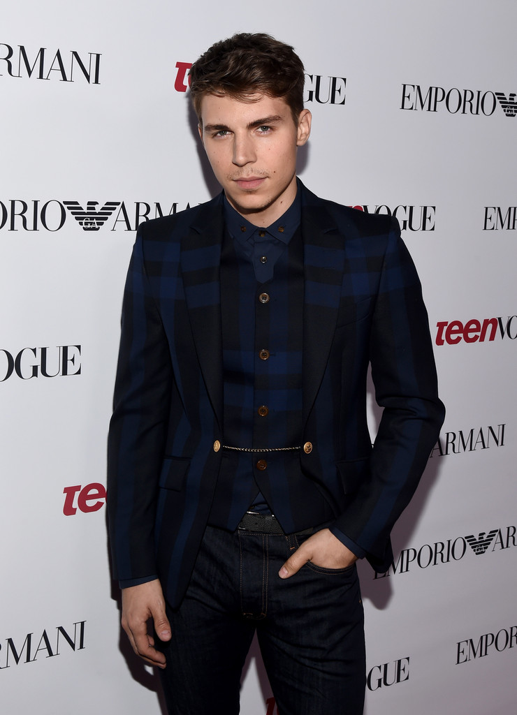 Attending Teen Vogue's 12th annual Young Hollywood party in Beverly Hills, California on September 26, 2014, actor Nolan Gerard Funk dressed to impress. For the special occasion, Funk wore a blue and black check jacket and shirt with blue denim jeans from British designer Vivienne Westwood.