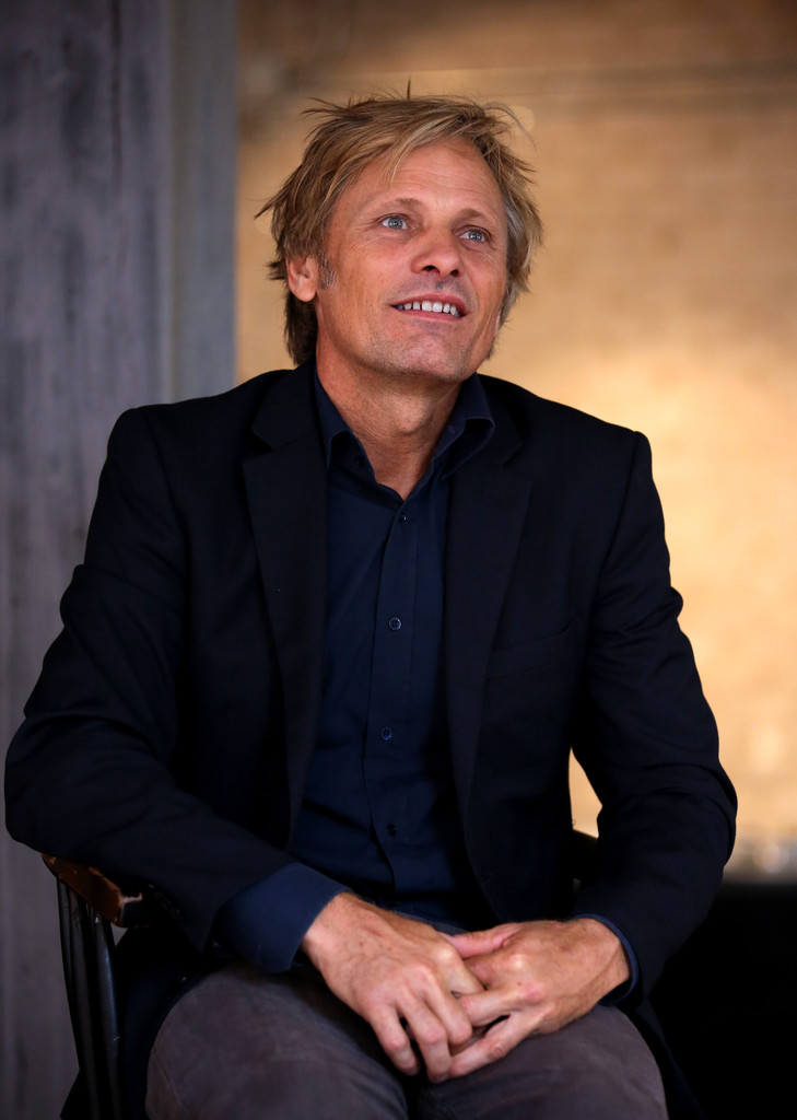 Taking part in the Toronto International Film Festival festivities, actor Viggo Mortensen was in town to promote 'Jauja'. Holding a press conference on September 11th, a newly blond Mortensen wore a navy dress shirt, black sports jacket and gray chinos, opting for a casual but sophisticated ensemble.