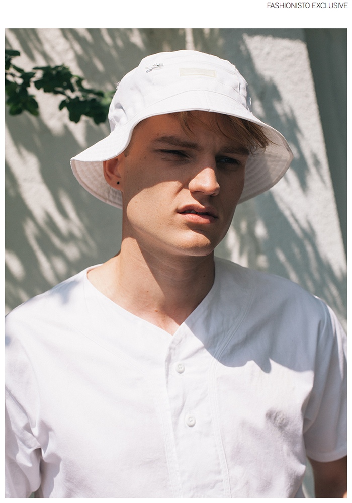 Zak wears vintage white bucket hat Iceberg and baseball shirt Stussy.